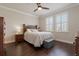 Bright bedroom with wood floors, ceiling fan, and plantation shutters on the windows at 597 Ozona Village Dr, Palm Harbor, FL 34683