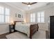Inviting bedroom with a wood sleigh bed, plantation shutters, and neutral decor at 597 Ozona Village Dr, Palm Harbor, FL 34683