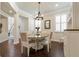 Elegant dining room with hardwood floors, chandelier lighting, and plantation shutters at 597 Ozona Village Dr, Palm Harbor, FL 34683