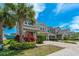 Well maintained two-story home features a paved driveway, manicured landscaping, and lovely curb appeal at 597 Ozona Village Dr, Palm Harbor, FL 34683