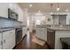 Bright kitchen with stainless steel appliances, tile backsplash, and granite counters at 597 Ozona Village Dr, Palm Harbor, FL 34683