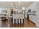 Open kitchen featuring white cabinets, granite countertops, stainless steel appliances, and a breakfast bar at 597 Ozona Village Dr, Palm Harbor, FL 34683
