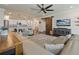 Open-concept living room features a kitchen, modern furnishings, and a cozy seating area at 597 Ozona Village Dr, Palm Harbor, FL 34683
