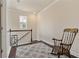 Cozy loft area with a rocking chair, neutral walls, and bright window at 597 Ozona Village Dr, Palm Harbor, FL 34683