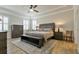 Spacious main bedroom with tray ceilings, plush carpeting, and large windows with plantation shutters at 597 Ozona Village Dr, Palm Harbor, FL 34683