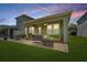 Relaxing covered patio with outdoor seating, string lights, and a fan at 597 Ozona Village Dr, Palm Harbor, FL 34683