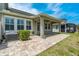 An inviting outdoor patio space with pavers and a covered area, perfect for relaxing or entertaining at 597 Ozona Village Dr, Palm Harbor, FL 34683
