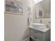 Contemporary powder room with a vessel sink, gray vanity, and stylish mirror at 597 Ozona Village Dr, Palm Harbor, FL 34683