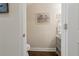 Charming powder room featuring a pedestal sink, wood floors, and coastal-themed decorations at 597 Ozona Village Dr, Palm Harbor, FL 34683