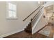 Elegant staircase with wood treads, white risers, and abundant natural light at 597 Ozona Village Dr, Palm Harbor, FL 34683