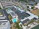 Aerial view featuring a sparkling community pool, tennis courts, and parking at 5980 Shore S Blvd # 403, Gulfport, FL 33707