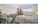 Bright bedroom featuring twin beds, a desk and a comfortable reading chair at 5980 Shore S Blvd # 403, Gulfport, FL 33707