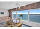 Bright dining area with a water view, a ceiling fan and seating for four at 5980 Shore S Blvd # 403, Gulfport, FL 33707
