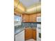 Galley kitchen features wood cabinets and stone countertops at 5980 Shore S Blvd # 403, Gulfport, FL 33707