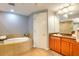 Bathroom with soaking tub, double vanities, and tile flooring at 600 Bayway Blvd # 304, Clearwater, FL 33767