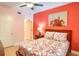Bright bedroom featuring a large window, ceiling fan, and colorful walls at 600 Bayway Blvd # 304, Clearwater, FL 33767