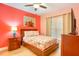 Bright bedroom featuring a large window, ceiling fan, and ample natural light at 600 Bayway Blvd # 304, Clearwater, FL 33767