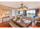 A well-appointed dining area seamlessly connects to the living room with waterfront views and a modern chandelier at 600 Bayway Blvd # 304, Clearwater, FL 33767