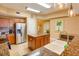 Spacious kitchen with stainless steel refrigerator, granite countertops, and a functional center island at 600 Bayway Blvd # 304, Clearwater, FL 33767