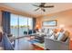 Inviting living room boasts water views from a large sliding glass door to the balcony and comfortable furniture at 600 Bayway Blvd # 304, Clearwater, FL 33767
