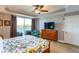 Cozy main bedroom featuring a waterfront view, ceiling fan, and warm natural light at 600 Bayway Blvd # 304, Clearwater, FL 33767
