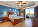 Inviting primary bedroom with wood floors, ceiling fan, and waterfront access at 600 Bayway Blvd # 304, Clearwater, FL 33767