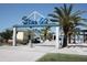 Entrance to Pier 60, featuring blue signage and palm trees for a picturesque welcome at 600 Bayway Blvd # 304, Clearwater, FL 33767