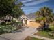 Charming one-story home with a manicured lawn, mature trees, and a spacious two car garage at 6018 Gannetdale Dr, Lithia, FL 33547