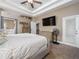 Comfortable bedroom with neutral tones, ceiling fan, and access to a private bathroom at 6018 Gannetdale Dr, Lithia, FL 33547