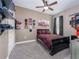 Bedroom features a black bed frame and car-themed decor on the walls and shelves at 6018 Gannetdale Dr, Lithia, FL 33547