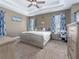Serene bedroom with a plush bed, tray ceiling, and tasteful decor creating a relaxing atmosphere at 6018 Gannetdale Dr, Lithia, FL 33547