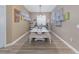 Bright dining room with bench seating, laminate floors, and unique wall decor at 6018 Gannetdale Dr, Lithia, FL 33547