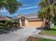 Charming one-story home with a manicured lawn, mature trees, and a spacious two car garage at 6018 Gannetdale Dr, Lithia, FL 33547