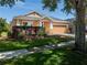 Well-maintained home with an attached two car garage, a lush lawn, and meticulously trimmed shrubbery at 6018 Gannetdale Dr, Lithia, FL 33547