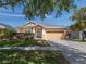 Charming one-story home featuring a manicured lawn, beautiful landscaping, and a spacious two car garage at 6018 Gannetdale Dr, Lithia, FL 33547