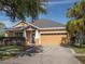 Charming one-story home with a manicured lawn, mature trees, and a spacious two car garage at 6018 Gannetdale Dr, Lithia, FL 33547