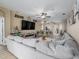 Open-concept living room boasts a large sectional sofa, ceiling fan, and seamless flow to the kitchen at 6018 Gannetdale Dr, Lithia, FL 33547