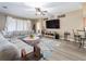 Spacious living room featuring a large sectional sofa, modern ceiling fan, and stylish decor at 6018 Gannetdale Dr, Lithia, FL 33547