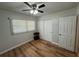 A clean, well-lit bedroom with laminate flooring, closet space, and a modern ceiling fan at 6047 67Th N Ave, Pinellas Park, FL 33781