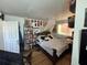 Bedroom featuring a queen-sized bed and a bookshelf filled with books and posters at 6047 67Th N Ave, Pinellas Park, FL 33781