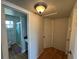Hallway leading to the bathroom features laminate floors, a ceiling light and doors at 6047 67Th N Ave, Pinellas Park, FL 33781