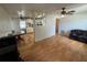 Open living room and dining area featuring sleek wood laminate floors, natural light, and modern ceiling fans at 6047 67Th N Ave, Pinellas Park, FL 33781