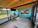 Outdoor screened-in porch with sink, mounted TV, and concrete flooring, perfect for enjoying the outdoors at 6047 67Th N Ave, Pinellas Park, FL 33781