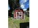 Charming red and white shed in backyard, offering convenient storage at 6047 67Th N Ave, Pinellas Park, FL 33781