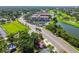 Scenic aerial shot showcasing a home nestled among trees near a golf course and tranquil lake at 6207 Gulfport S Blvd, Gulfport, FL 33707