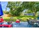 Charming backyard with mature trees, outdoor seating, and fire pit at 6207 Gulfport S Blvd, Gulfport, FL 33707