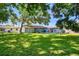 Lush green backyard featuring a patio with an umbrella, perfect for outdoor relaxation and entertainment at 6207 Gulfport S Blvd, Gulfport, FL 33707