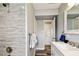 Bathroom showcasing a tiled shower, white towels, and modern fixtures at 6207 Gulfport S Blvd, Gulfport, FL 33707