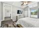 Bright bedroom featuring wood flooring, an ensuite bathroom and exterior views at 6207 Gulfport S Blvd, Gulfport, FL 33707