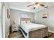Bedroom featuring a modern bed frame, ceiling fan, and wood laminate flooring at 6207 Gulfport S Blvd, Gulfport, FL 33707